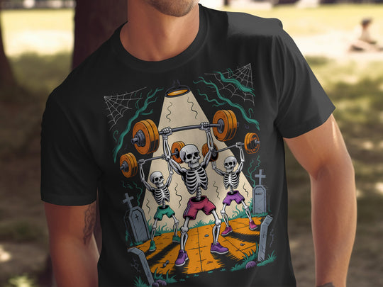 Person wearing a black t-shirt with a colorful graphic of skeletons lifting weights.