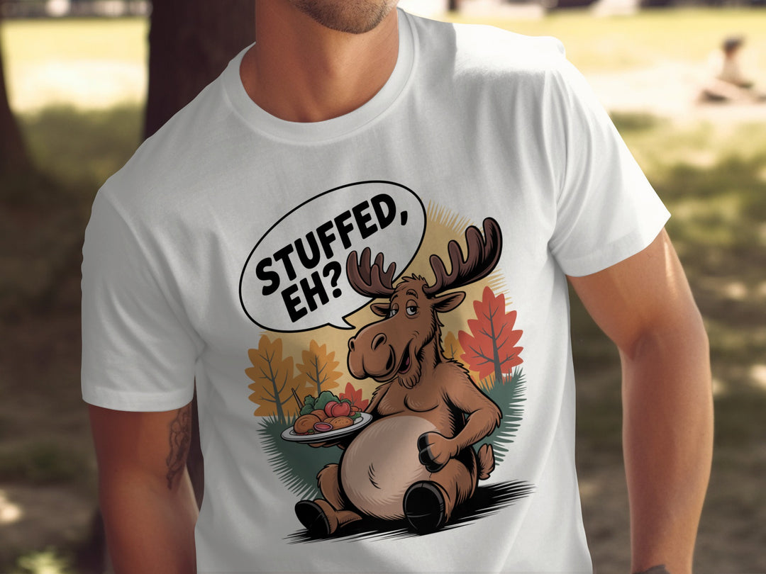 Person wearing a white t-shirt with a cartoon moose graphic and text 'STUFFED, EH?' in an outdoor setting.