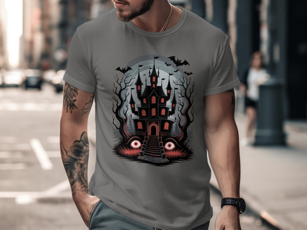 Person wearing a charcoal t-shirt with a castle design on a city street