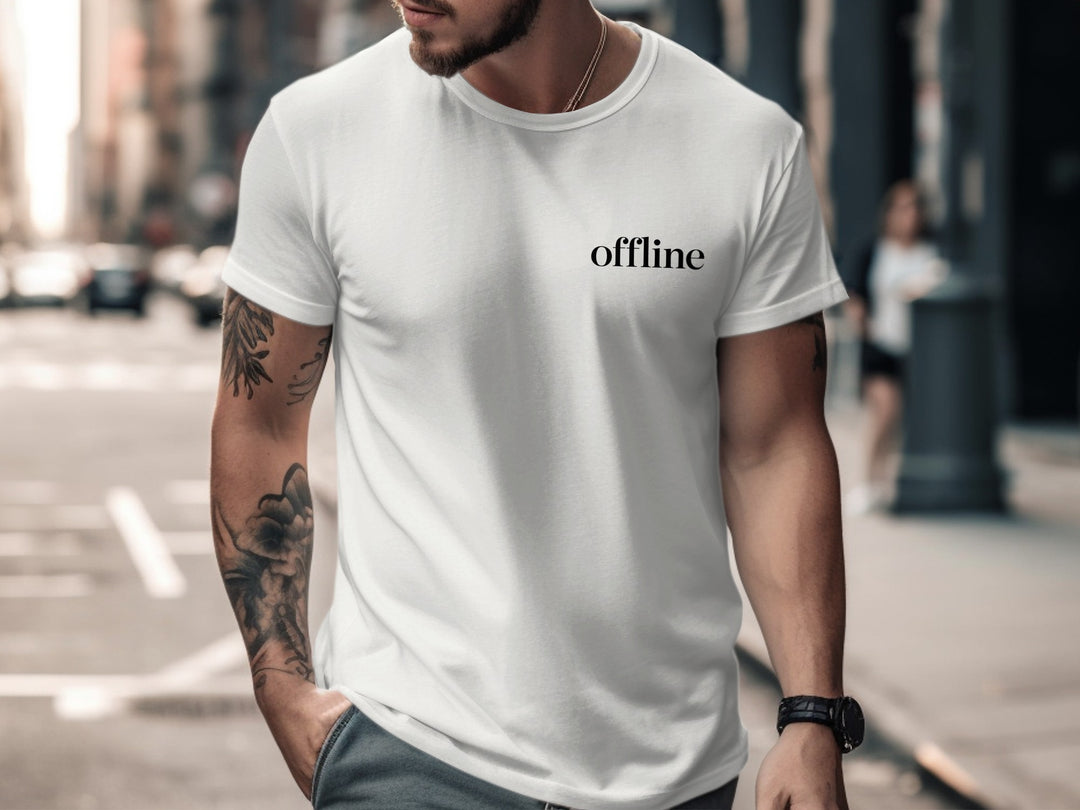 Man wearing a white t-shirt with 'offline' text on a city street.