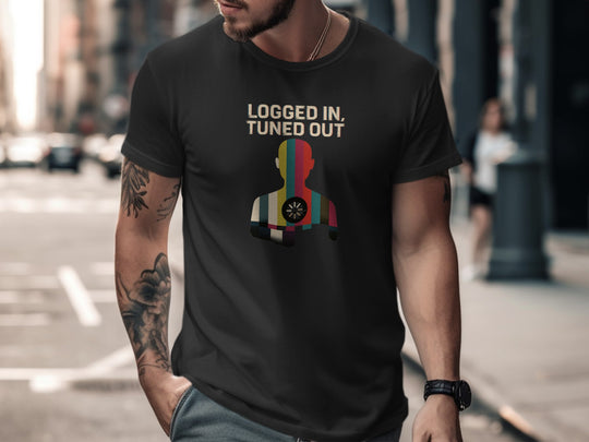 Man wearing a black t-shirt with colorful graphic and text on a city street.