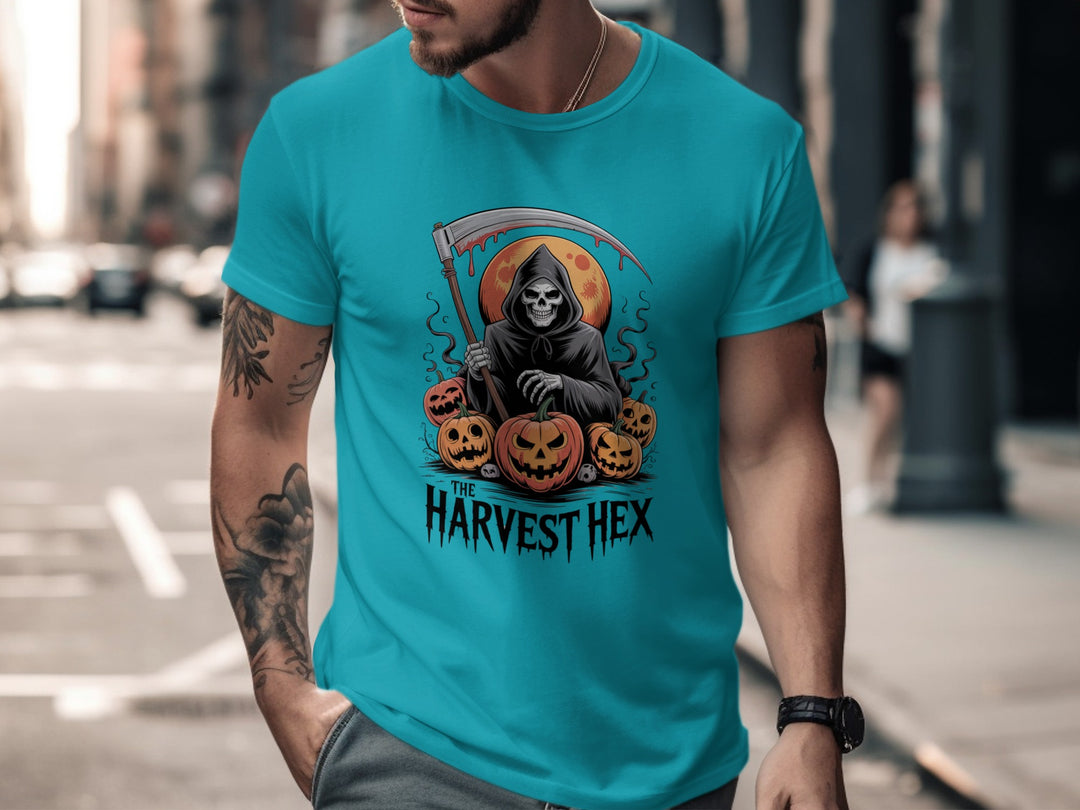 Person wearing a turquoise t-shirt with a graphic design of a skeleton holding a scythe and pumpkins, with 'The Harvest Hex' text, on a city street.