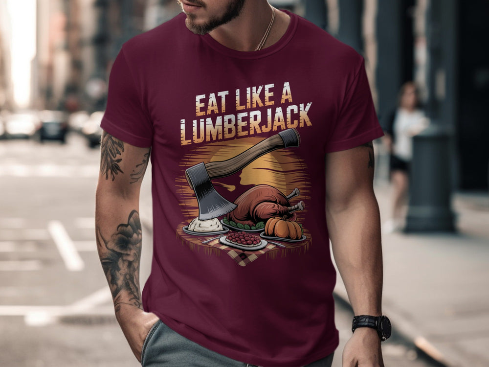 Man wearing a maroon t-shirt with 'Eat Like a Lumberjack' graphic design on a city street.