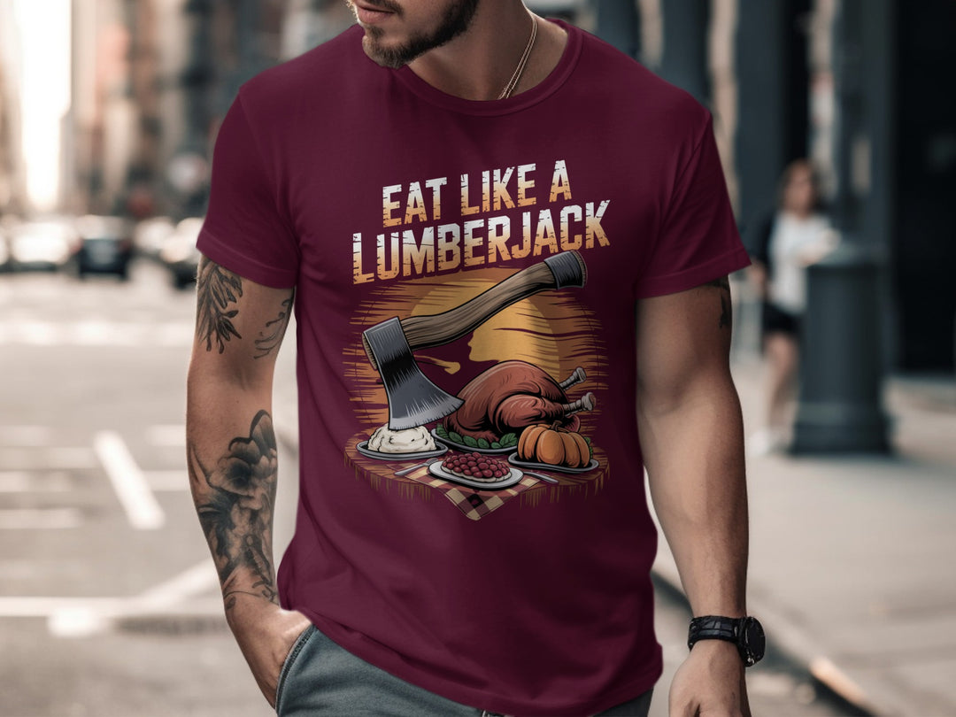 Man wearing a maroon t-shirt with 'Eat Like a Lumberjack' graphic design on a city street.