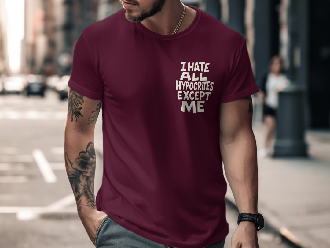Man wearing a maroon t-shirt with text on a city street