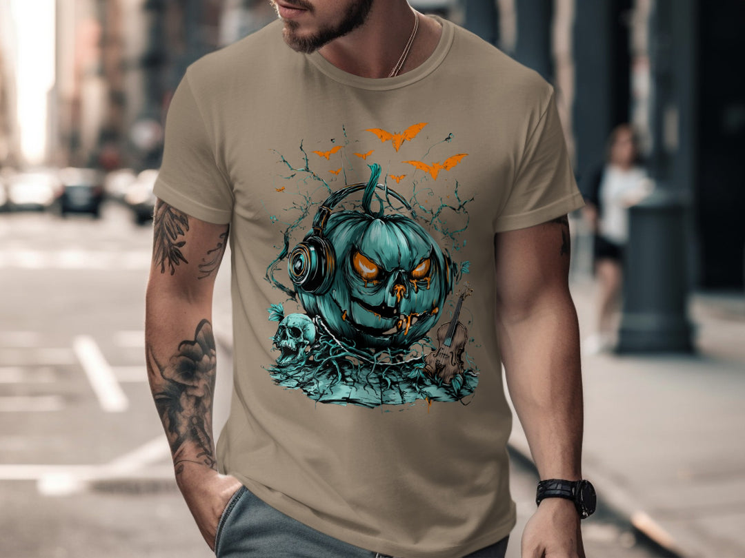 Man wearing a sand color t-shirt with a blue pumpkin graphic on a city street.
