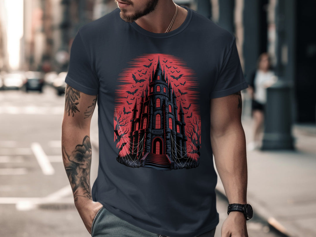 Man wearing a navy t-shirt with a red and black graphic design on a city street.