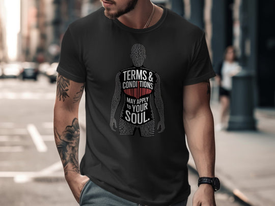 Man wearing a black t-shirt with a graphic design and text on a city street.