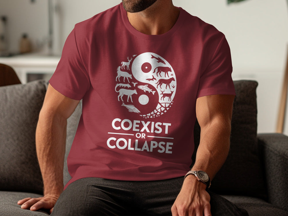 Person wearing a maroon t-shirt with 'Coexist or Collapse' design sitting on a couch.