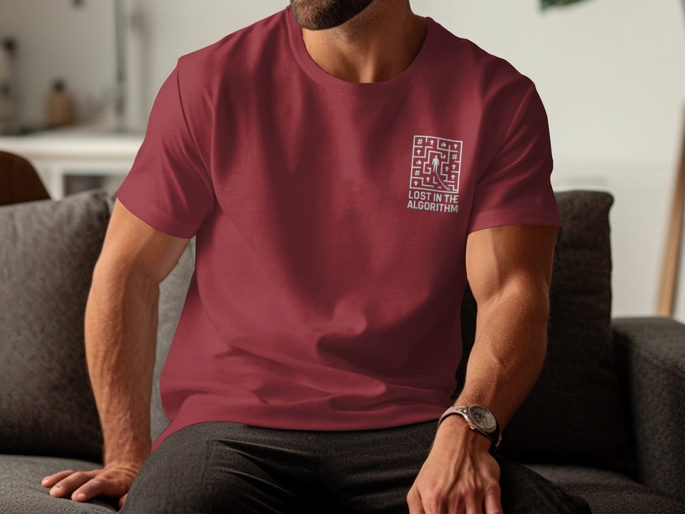 Person wearing a maroon t-shirt with a QR code design sitting on a couch.