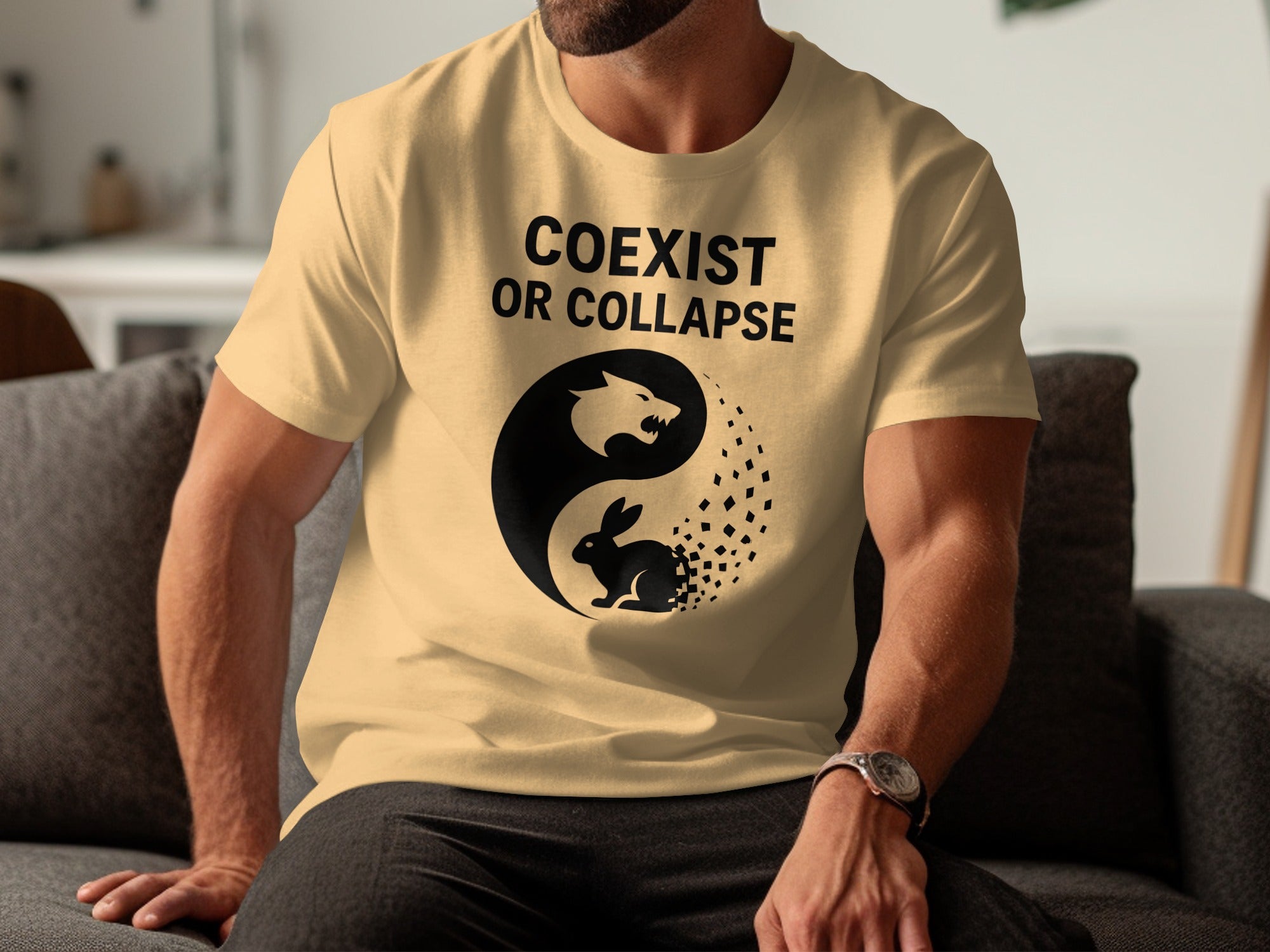 Person wearing a beige t-shirt with 'Coexist or Collapse' design and yin yang symbol.