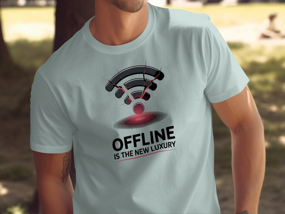 Person wearing a light blue t-shirt with a graphic design and text 'Offline is the New Luxury'.