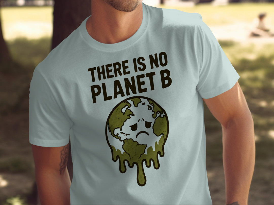 Person wearing a light blue t-shirt with a graphic and text 'There is no planet B' in an outdoor setting.