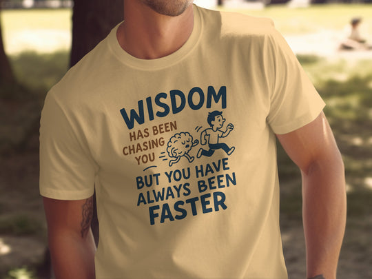 Person wearing a yellow t-shirt with a funny quote and graphic design.