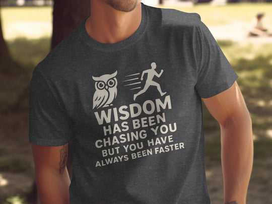 Person wearing a charcoal gray t-shirt with an owl and running person graphic and text.
