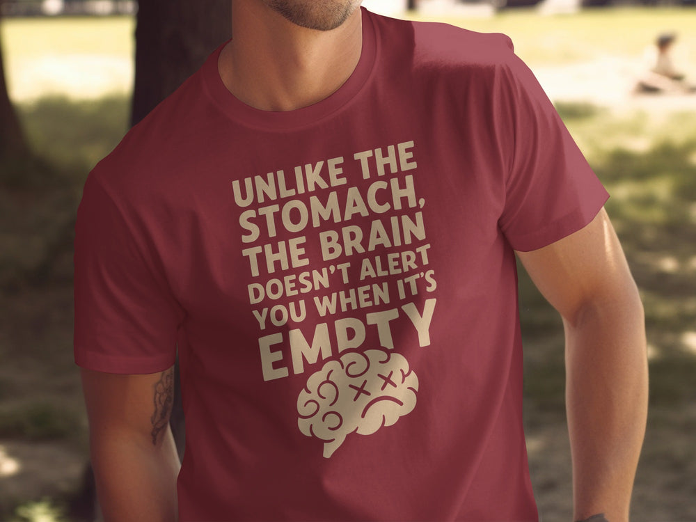 Maroon t-shirt with humorous text and brain graphic worn by a person outdoors.