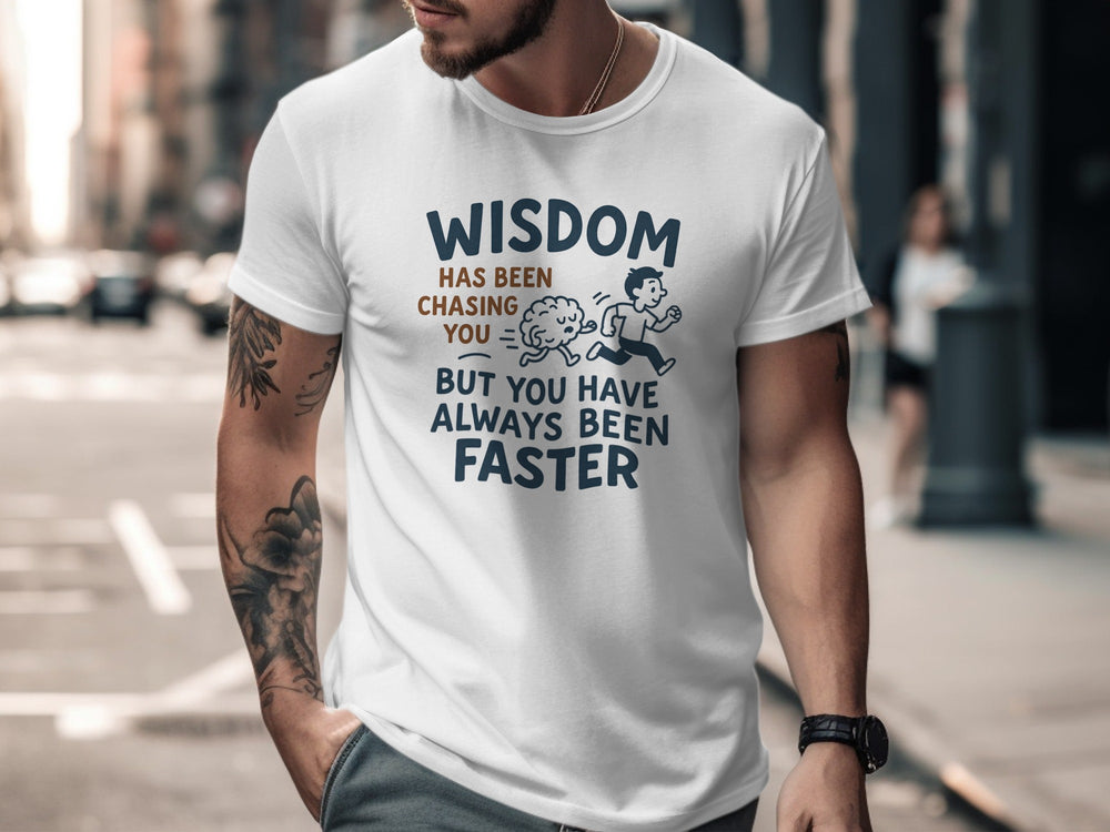 Man wearing a white t-shirt with a funny quote on a city street.