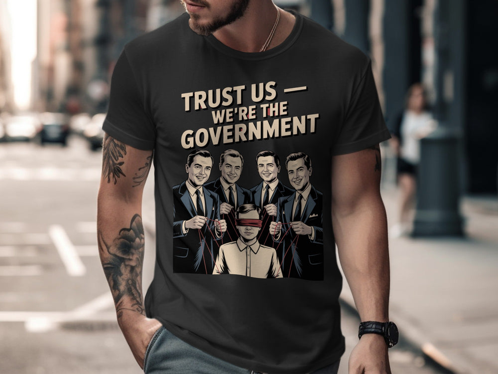 Person wearing a black t-shirt with graphic design and text on a city street.