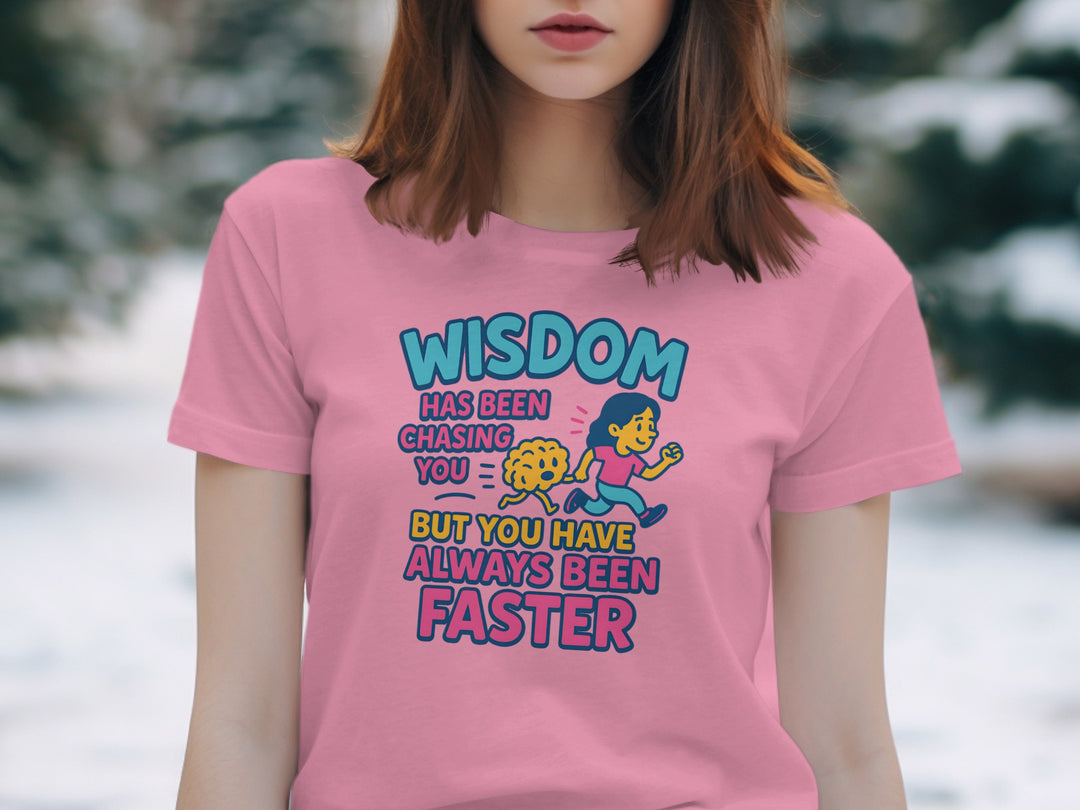 Person wearing a pink t-shirt with a humorous quote and graphic design.