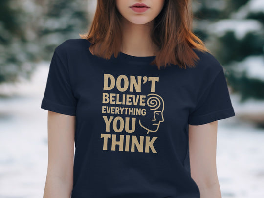 Person wearing a navy t-shirt with a motivational quote outdoors
