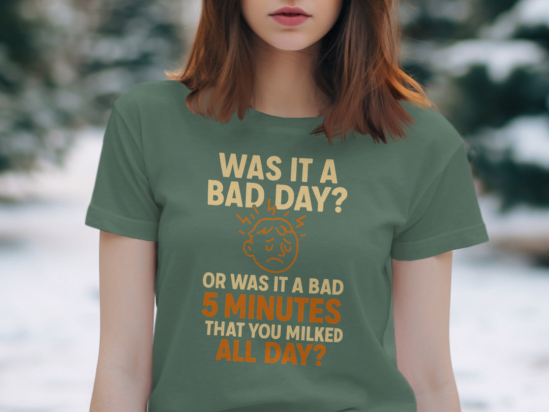 Person wearing a green t-shirt with humorous text in a snowy outdoor setting