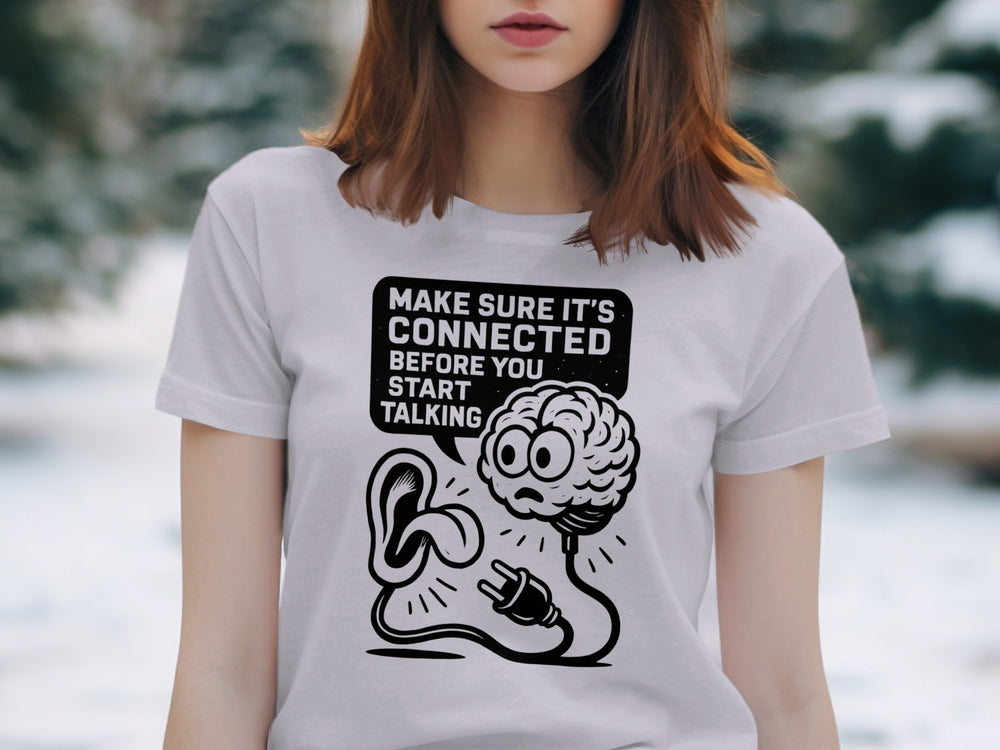 Person wearing a lavender t-shirt with a graphic design and text in a snowy outdoor setting