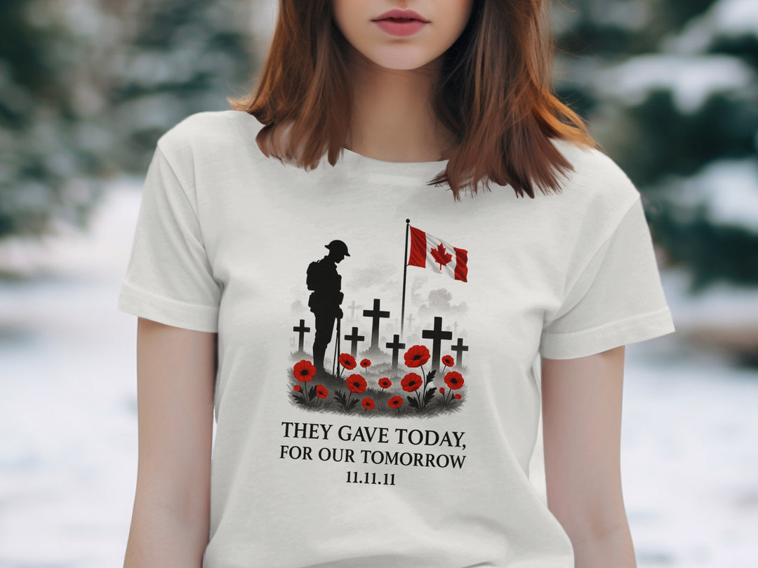 Person wearing a off white t-shirt with a memorial design and Canadian flag.