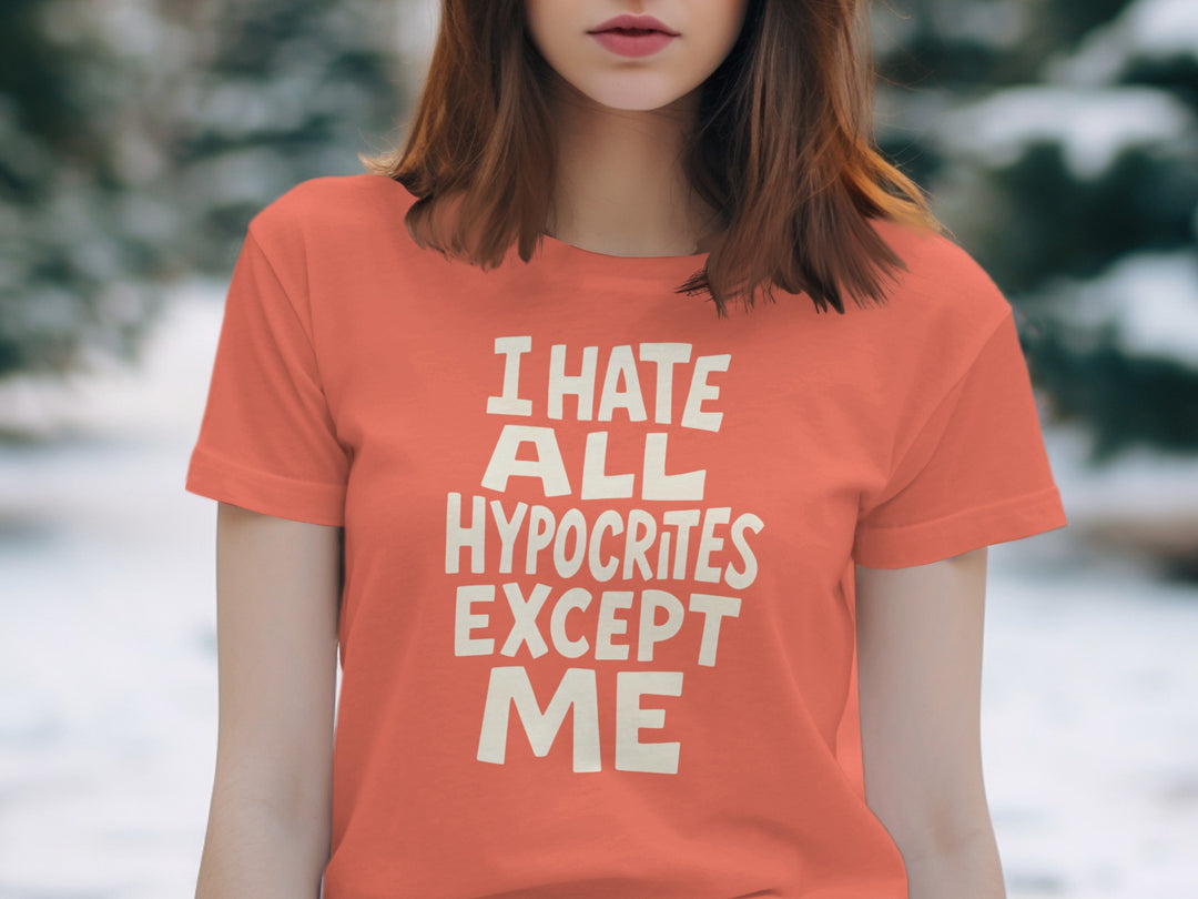 Person wearing an orange t-shirt with text in a snowy outdoor setting