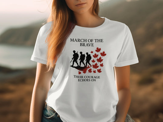 Person wearing a off white t-shirt with 'March of the Brave' design outdoors.