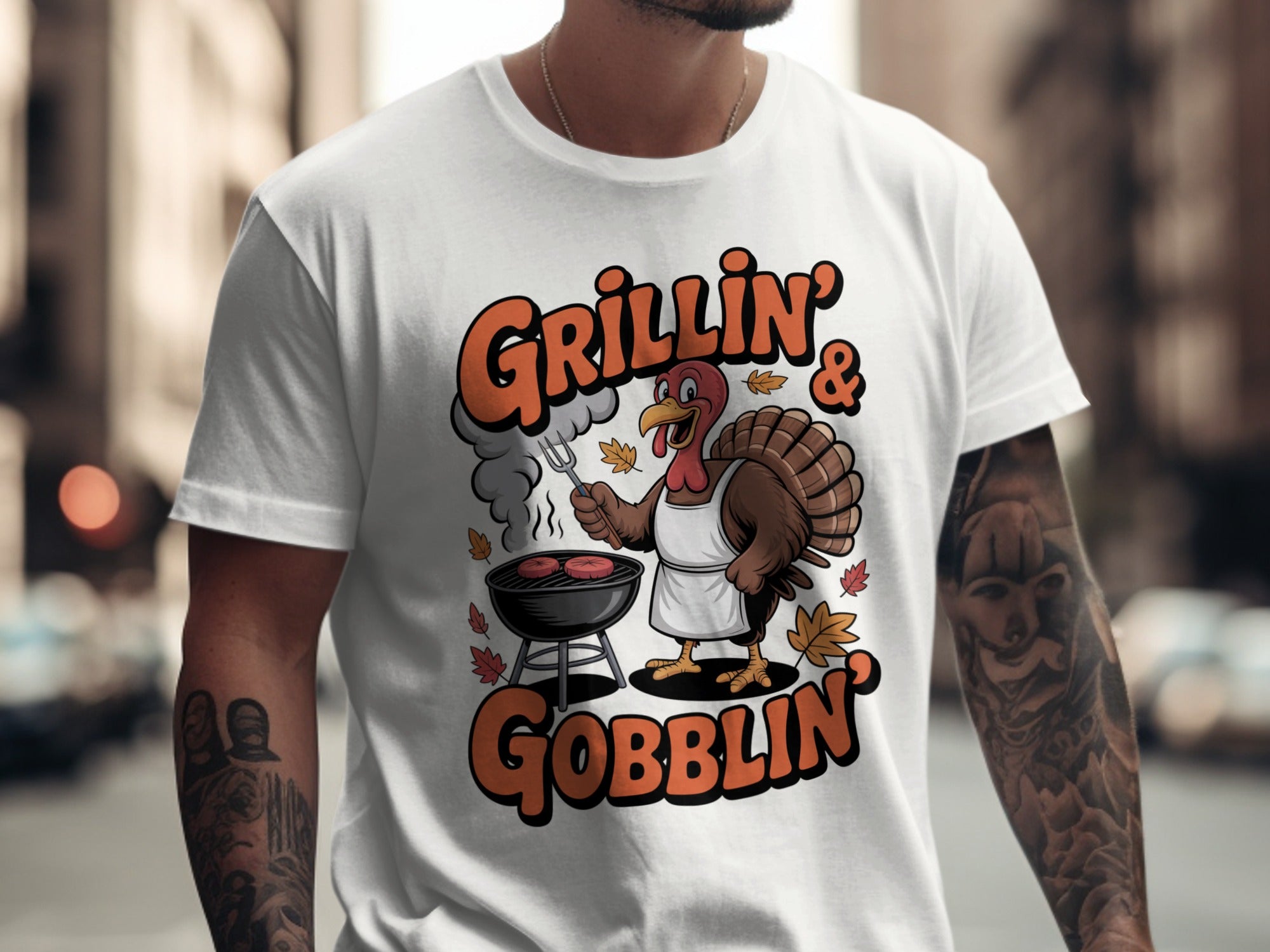 Person wearing a white t-shirt with a turkey graphic and text 'Grillin' & Gobblin' on a city street.