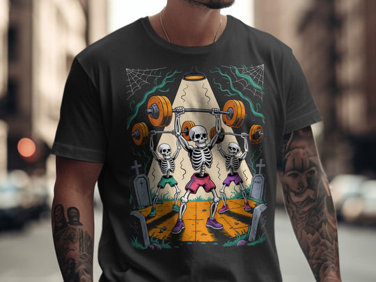 Person wearing a black t-shirt with a colorful graphic of skeletons lifting weights.