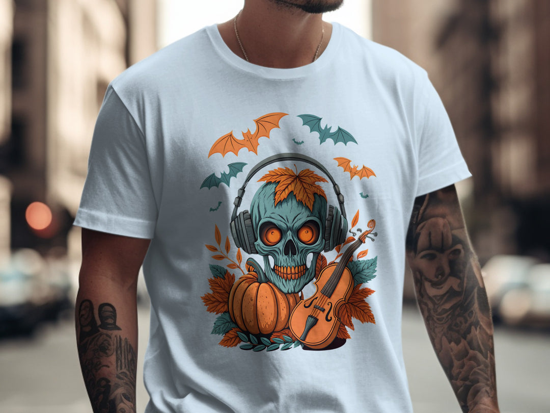Person wearing a light blue t-shirt with a colorful graphic design featuring a skull, pumpkin, and violin.