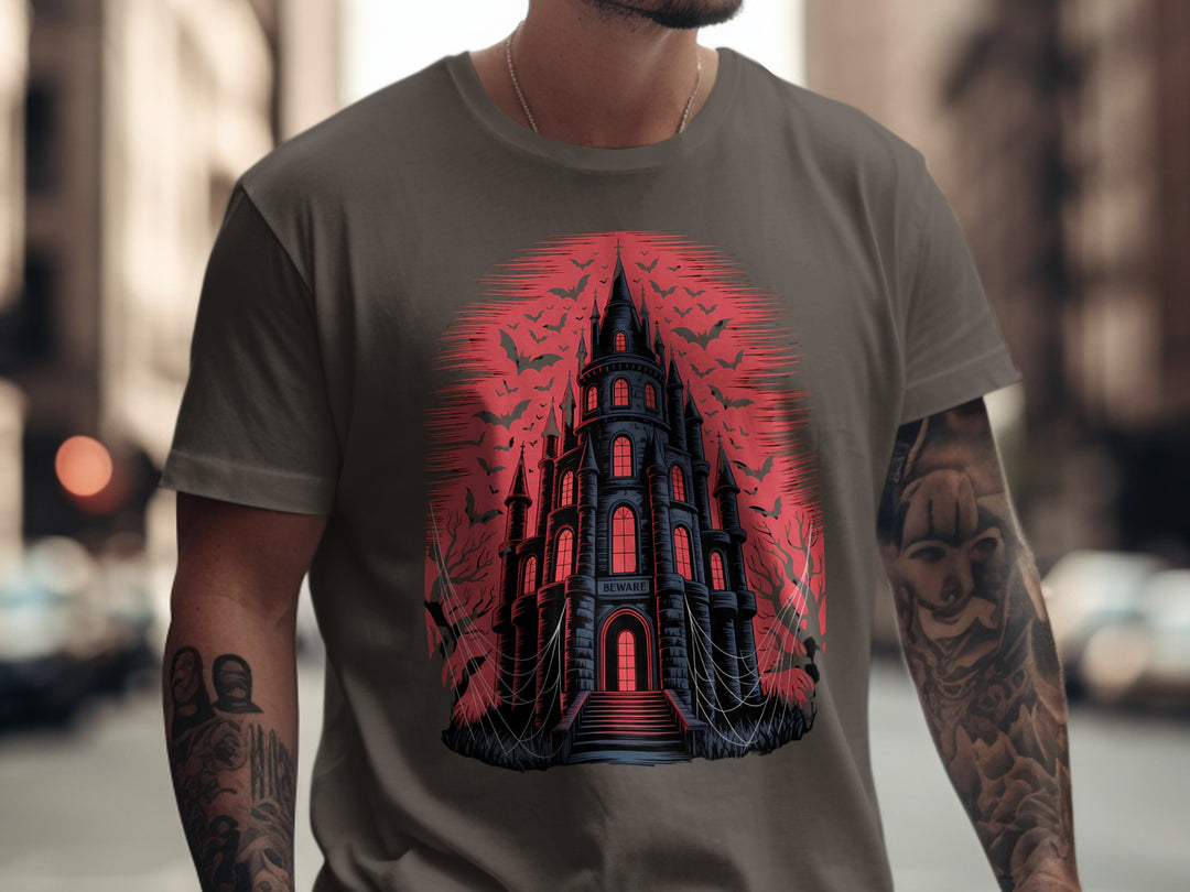 Person wearing a dark chocolate t-shirt with a castle design in red and black.