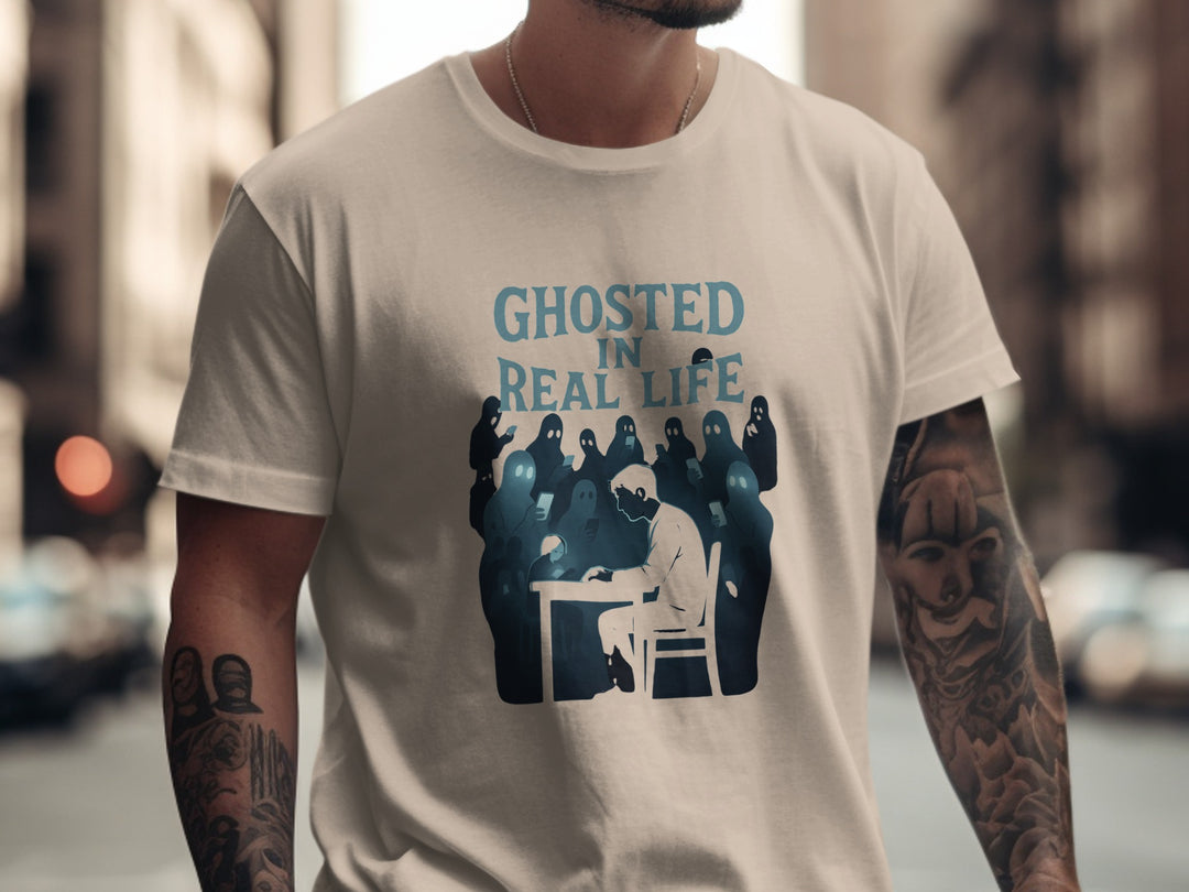Person wearing a sand color t-shirt with 'Ghosted in Real Life' graphic design.