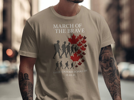 Person wearing a brown savana t-shirt with 'March of the Brave' design featuring silhouettes and a red maple leaf.