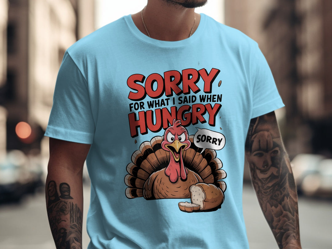 Person wearing sky blue t-shirt with a cartoon turkey graphic and text in an urban setting.