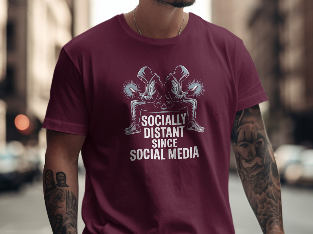 Person wearing a maroon t-shirt with a graphic and text in an urban setting