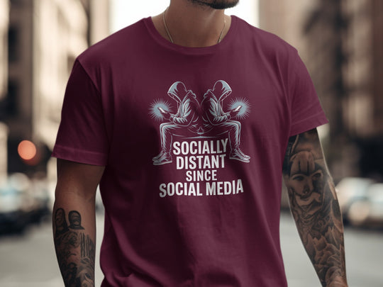 Person wearing a maroon t-shirt with a graphic and text in an urban setting