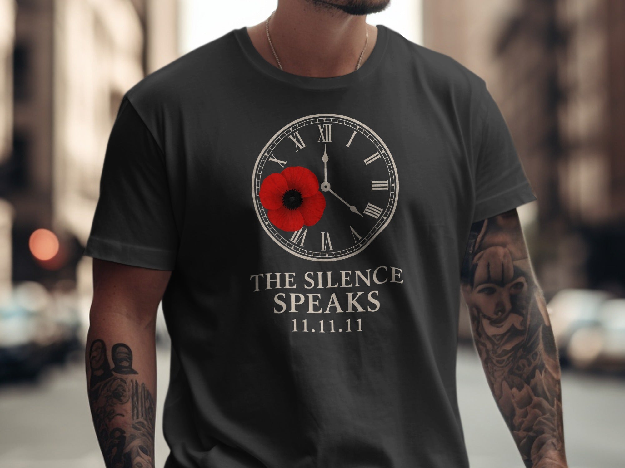 Person wearing a black t-shirt with a clock and poppy design, text 'The Silence Speaks 11.11.