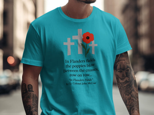 Person wearing a blue t-shirt with a poppy and cross design and text.