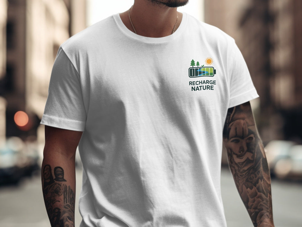 Person wearing a white t-shirt with a logo and text in an urban setting