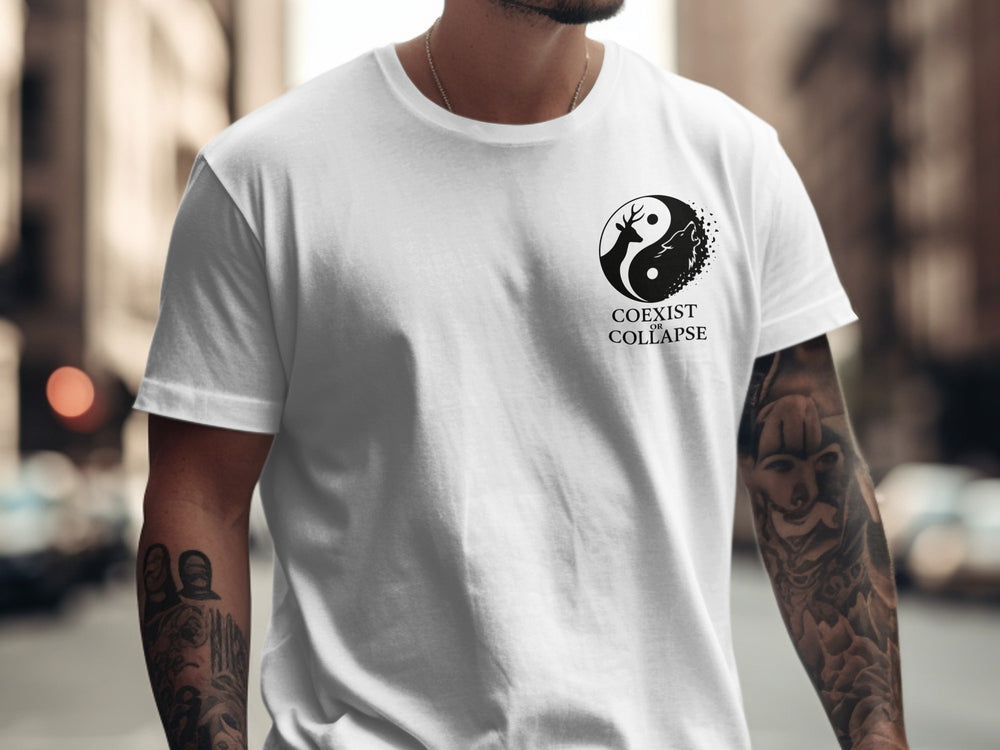 Person wearing a white t-shirt with a black logo and text, standing in an urban setting.