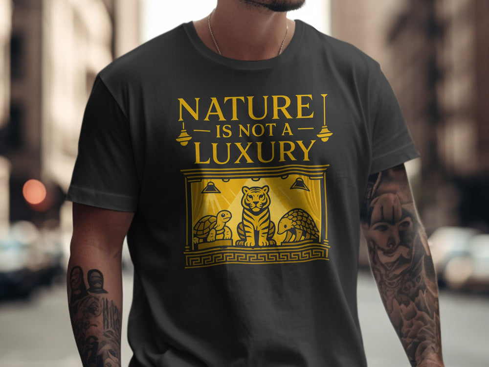 Person wearing a black t-shirt with a gold graphic and text 'NATURE IS NOT A LUXURY' on a city street.