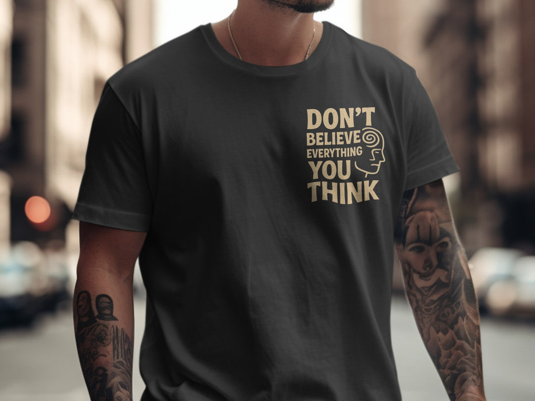 Person wearing a black t-shirt with 'DON'T BELIEVE EVERYTHING YOU THINK' text on a city street.