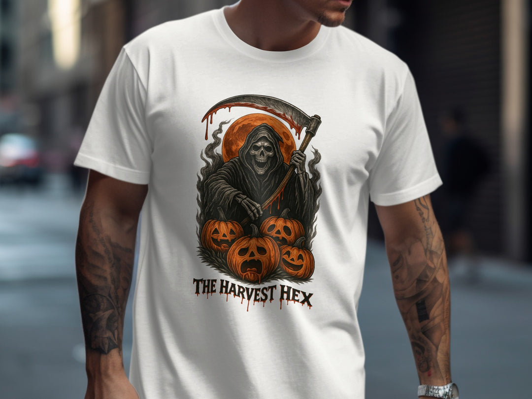 Person wearing a white t-shirt with a graphic design of a Grim Reaper and pumpkins, with 'The Harvest Hex' text.