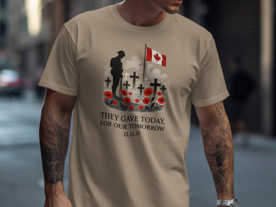 Person wearing a brown savana t-shirt with a graphic design featuring a soldier, crosses, and a Canadian flag.
