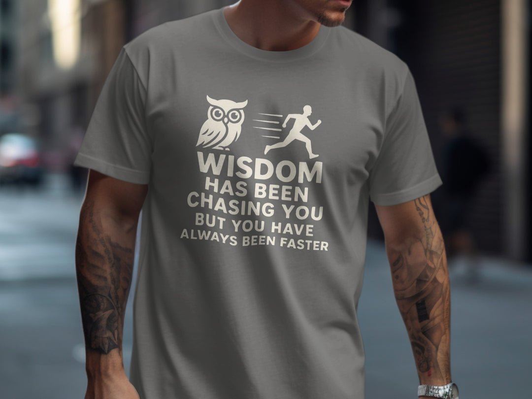 Person wearing a charcoal t-shirt with a motivational quote and owl graphic.