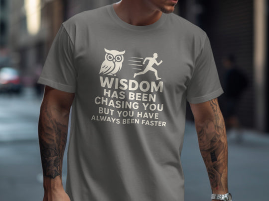 Person wearing a charcoal t-shirt with a motivational quote and owl graphic.