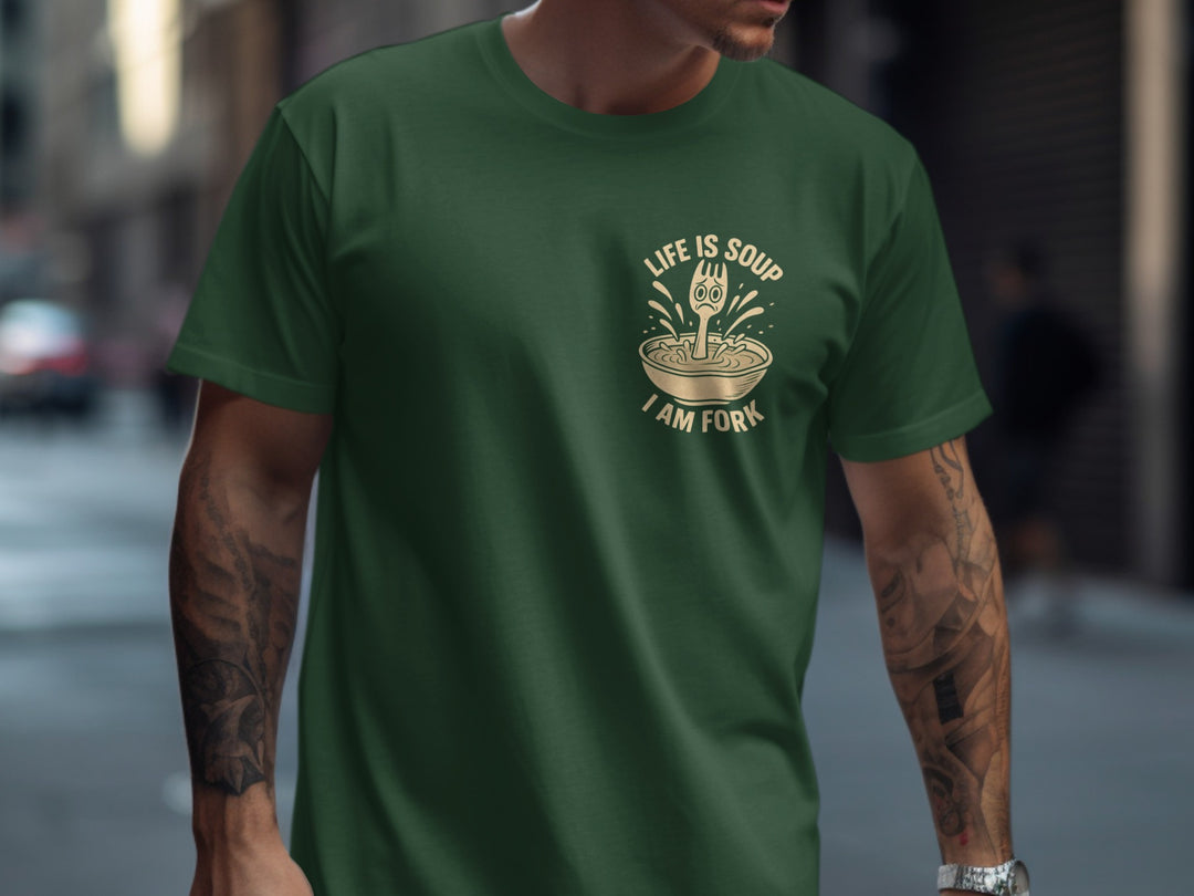 Person wearing a green t-shirt with a graphic design on a city street.