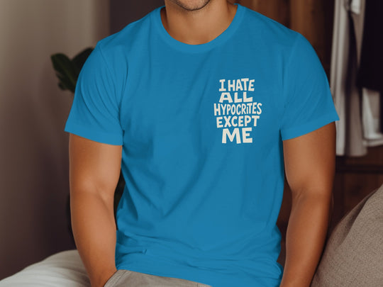 Person wearing a sapphire blue t-shirt with text in a room.